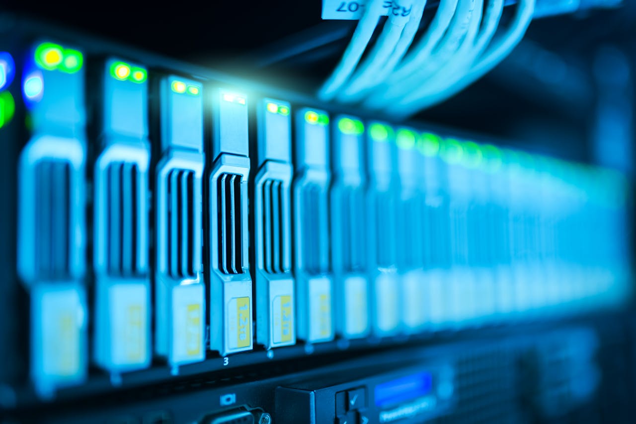 Home Detailed image of a server rack with glowing lights in a modern data center.