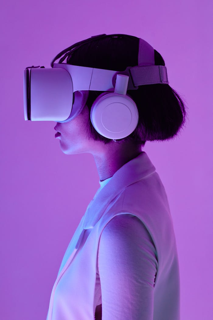 Home Side profile of a woman wearing VR goggles in a studio with purple lighting, embodying future tech.
